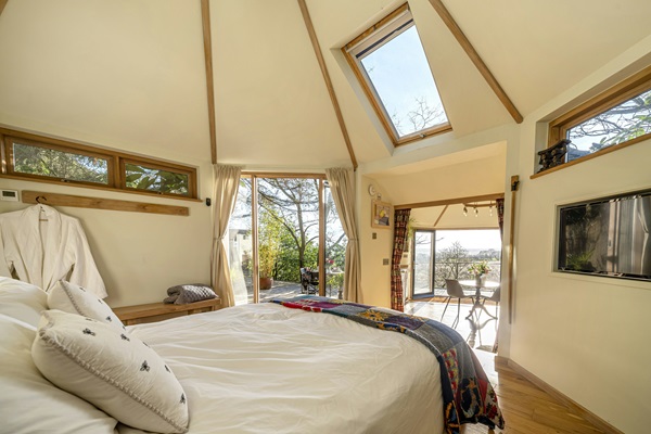 Treehouse stay at Happenoak - bedroom view out to lounge and up through rooftop windows